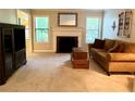Inviting living room with a cozy fireplace, neutral carpet, and a comfortable brown sofa at 1612 Huntingdon, Atlanta, GA 30350
