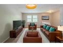 Comfortable living room showcasing a seating arrangement, plush carpet, and natural lighting at 2242 Cherokee Valley Cir, Lithonia, GA 30058