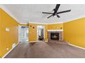 Spacious living room with a brick fireplace, ceiling fan, and carpet flooring at 573 Hambrick Sq, Stone Mountain, GA 30083