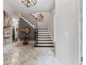 Elegant foyer with marble floors, a staircase, and stylish decor at 1292 Lenox Park Ne Blvd, Brookhaven, GA 30319