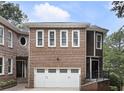 Charming brick home with a two-car garage and landscaped front yard at 1292 Lenox Park Ne Blvd, Brookhaven, GA 30319