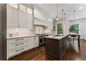 Modern kitchen with white cabinets, stainless steel appliances, and a center island at 1292 Lenox Park Ne Blvd, Brookhaven, GA 30319