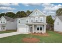 Charming two-story home with a manicured lawn and a welcoming front porch at 251 Arnewood Cir, Mcdonough, GA 30253