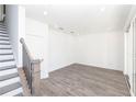 Bright, open-concept living area with sleek gray flooring and staircase access at 362 Olmstead Way # 23, Alpharetta, GA 30022