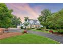 Exterior view of the house, garage, circle drive, and landscaped front yard at 150 Trinity Farm Dr, Canton, GA 30115