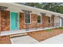 Charming front porch with ornate iron railings and a bright blue front door at 1869 Hebron Hills Dr, Tucker, GA 30084