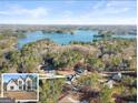 Breathtaking aerial view showcasing the home's proximity to the lake and surrounding forest at 3735 Tamiami Trl, Cumming, GA 30041