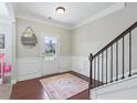 Inviting entryway with beautiful floors, staircase, and decorative details at 6160 Oriole Ln, Cumming, GA 30028