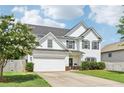 Beautiful two-story home featuring a manicured lawn and attached two car garage at 6160 Oriole Ln, Cumming, GA 30028