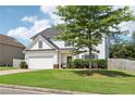 Lovely two-story home with green lawn, attached garage, and beautiful architectural details at 6160 Oriole Ln, Cumming, GA 30028