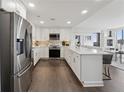 Spacious kitchen with stainless steel appliances, white cabinets, marble counters and breakfast bar seating at 75 14Th Ne St # 3820, Atlanta, GA 30309
