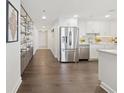 Modern kitchen featuring stainless steel appliances, white cabinets, and stylish shelving near the entryway at 75 14Th Ne St # 3820, Atlanta, GA 30309