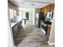 Updated kitchen with stainless steel appliances, wood cabinetry, and granite countertops at 563 Fieldgreen Dr, Jonesboro, GA 30238