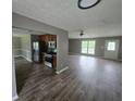 Open-concept living room and kitchen with hardwood floors and stainless steel appliances at 563 Fieldgreen Dr, Jonesboro, GA 30238