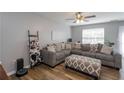 Comfortable living room with a large sectional sofa, wood floors, and ceiling fan at 183 Venture Path, Hiram, GA 30141