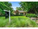Charming front exterior showcasing lush green lawn, mature trees, and 'for sale' sign at 1181 Fairview Ne Rd, Atlanta, GA 30306