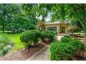 Landscaped front yard with sculpted bushes, trees, and a stone walkway leading to the house at 1181 Fairview Ne Rd, Atlanta, GA 30306