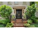 Elegant double doors with a covered porch and beautiful landscaping provide a welcoming entrance at 2525 Peachtree Rd # 28, Atlanta, GA 30305