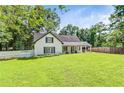 Beautiful home with lush lawn, and a white picket fence. Inviting, scenic exterior at 2896 Tiffany Cir, Lawrenceville, GA 30044