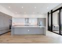 Spacious modern kitchen featuring white cabinets, stainless steel appliances, and a large island at 2425 Peachtree Rd # 1806, Atlanta, GA 30305
