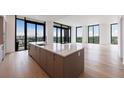 Sleek, modern kitchen with a large island and floor-to-ceiling windows at 2425 Peachtree Rd # 1806, Atlanta, GA 30305