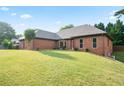 Lovely brick home with an expansive, green lawn and appealing landscaping at 300 Saddle Creek Ln, Roswell, GA 30076