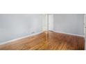 Bright living room showing pristine hardwood floors, neutral-colored walls, and an open doorway to another room at 734 Meadowlark Dr, Villa Rica, GA 30180