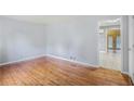 Bright living room showcasing beautiful hardwood floors, light-colored walls, and open doorway to another room at 734 Meadowlark Dr, Villa Rica, GA 30180