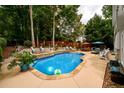 Backyard showcasing a sparkling swimming pool, surrounded by lounge chairs and a privacy fence at 1767 Tidewell Trce, Lawrenceville, GA 30043