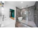 Modern bathroom with a glass-enclosed shower, soaking tub, double vanity and stylish fixtures at 32 Walthall Ne St # A, Atlanta, GA 30307
