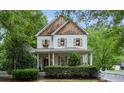 Beautiful two-story home featuring cedar shake accents, light-colored siding, and a covered front porch at 2177 Mauldin Nw St, Atlanta, GA 30318
