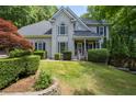 Charming two-story home featuring manicured landscaping, and a well-maintained lawn at 3511 Stone Cliff Way, Woodstock, GA 30189