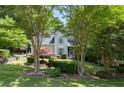 Lush front yard featuring mature landscaping provides a serene and inviting atmosphere at 3511 Stone Cliff Way, Woodstock, GA 30189
