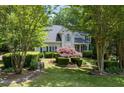 Well-maintained front yard with mature trees and manicured landscaping enhances curb appeal at 3511 Stone Cliff Way, Woodstock, GA 30189