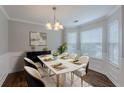 Elegant dining area with stylish chandelier, seating for six, and bay window, perfect for formal gatherings at 4185 Post Oak Grv, Atlanta, GA 30349
