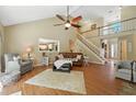 Open living room boasts vaulted ceiling, hardwood floors, and a staircase to upper level at 912 Spring Vly, Woodstock, GA 30189