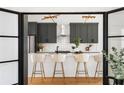 Beautiful, updated kitchen boasts gray cabinets, barstool seating, stainless appliances, and unique lighting at 941 Garibaldi Sw St, Atlanta, GA 30310
