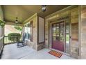 Charming covered front porch, featuring stone accents and a rocking chair for relaxed outdoor living at 1524 Guthrie Crossing Dr, Loganville, GA 30052