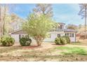 Well-maintained front yard featuring a mature tree and manicured shrubbery, adding to the home's curb appeal at 1749 Lauranceae Way, Riverdale, GA 30296