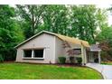 Home's exterior features a charming yard, complemented by lush green trees at 3402 Wynnewood Ln, Duluth, GA 30096