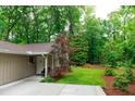 Exterior of home featuring lush green trees with a neatly manicured front yard at 3402 Wynnewood Ln, Duluth, GA 30096