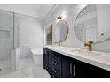 Modern bathroom with double sinks, marble countertops, gold fixtures, and a soaking tub at 140 Ashewoode Downs Ln, Johns Creek, GA 30005