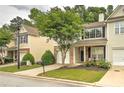 Charming townhome with a manicured lawn and a quaint front porch seating area at 1643 Jackson Nw Way, Atlanta, GA 30318
