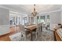 Elegant dining room featuring hardwood floors, chandelier and natural lighting at 390 Wilde Green Dr, Roswell, GA 30075
