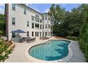 Inviting backyard pool with lounge area and well-maintained landscaping at 390 Wilde Green Dr, Roswell, GA 30075