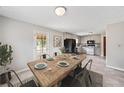 Dining room with a rustic wooden table, stylish chairs, and natural light at 58 6Th W Ave, Dallas, GA 30157