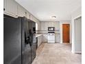 Bright kitchen with stainless steel refrigerator and neutral flooring at 58 6Th W Ave, Dallas, GA 30157