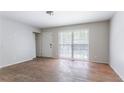 Bright bedroom features wood floors, neutral paint, closet, and a large window letting in plenty of natural light at 4337 Brookside Dr, Forest Park, GA 30297