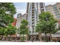 Contemporary high-rise building with tree lined sidewalks and ground floor shops at 855 Peachtree Ne St # 1108, Atlanta, GA 30308