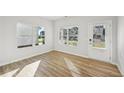 Sunlit bedroom with durable hardwood floors, an exterior door, and bright windows at 11857 Rizvan Pl, Covington, GA 30014